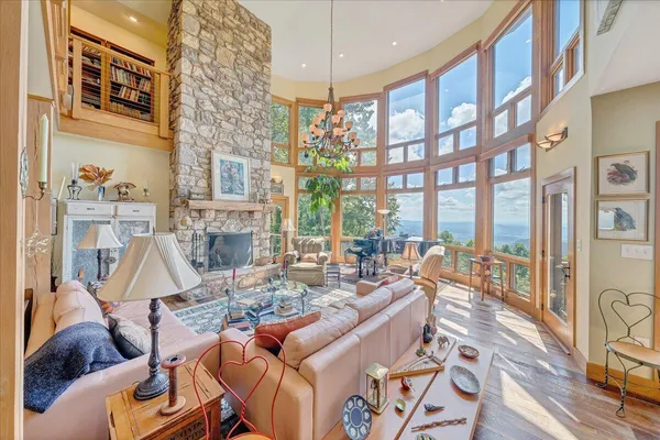 a living room with fireplace furniture and a large window