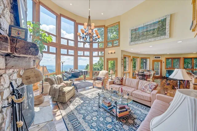 a living room with fireplace furniture and a large window