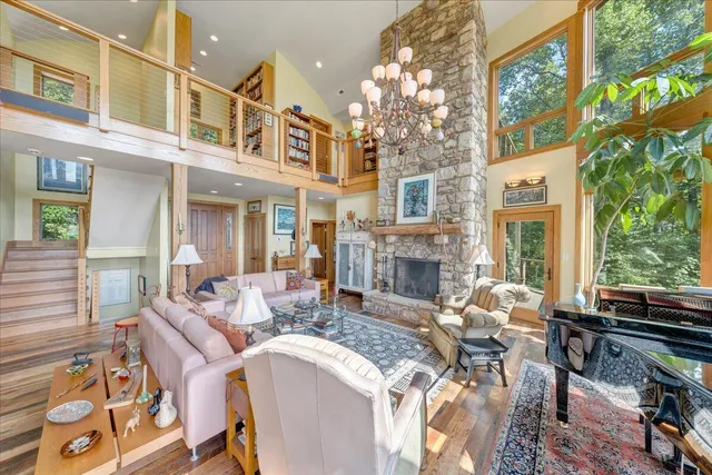 a living room with furniture a wooden floor and white walls