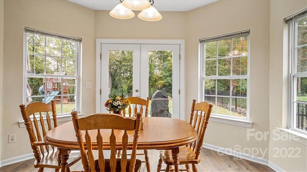 2001 Dataw Lane Indian Trail, NC 28079 - Photo 15 of 38 a dining room with furniture a chandelier and wooden floor
