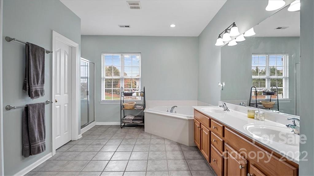 2001 Dataw Lane Indian Trail, NC 28079 - Photo 21 of 38 a spacious bathroom with a tub sink and mirror