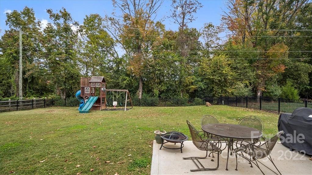 2001 Dataw Lane Indian Trail, NC 28079 - Photo 31 of 38 a view of a backyard with furniture and a slide