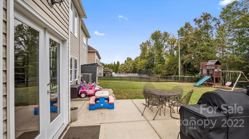 2001 Dataw Lane Indian Trail, NC 28079 - Photo 32 of 38 a view of a patio with couches chairs and potted plants