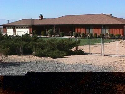17170 Yucca Road Apple Valley, CA 92307 - Photo 1 of 1 a view of a house with a yard
