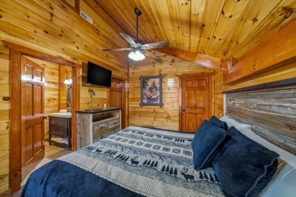 a bedroom with a bed and a bookshelf