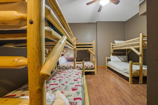 a bedroom with a bed and wooden floor