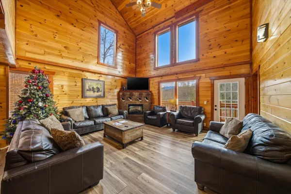 a view of a patio with couches chairs and wooden floor