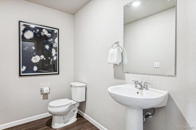 a bedroom with a bed chandelier and a window
