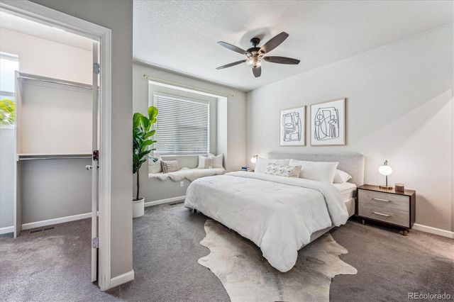 a bedroom with a bed and a potted plant