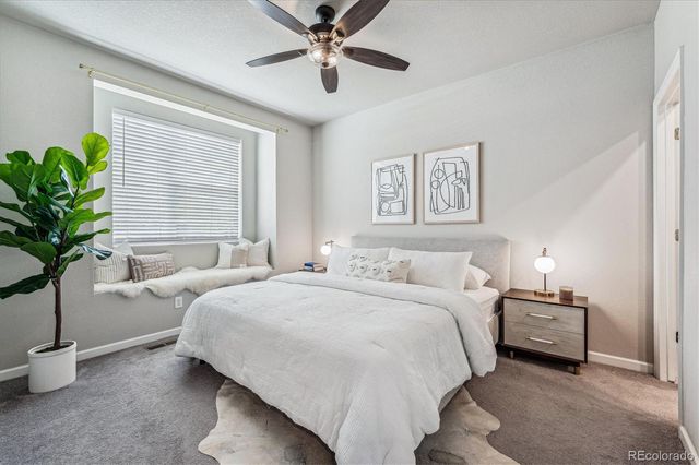 a bedroom with a bed and painting on the wall