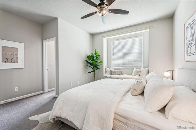 a bathroom with a granite countertop sink a toilet a mirror and shower