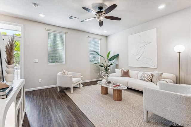 a living room with furniture and wooden floor
