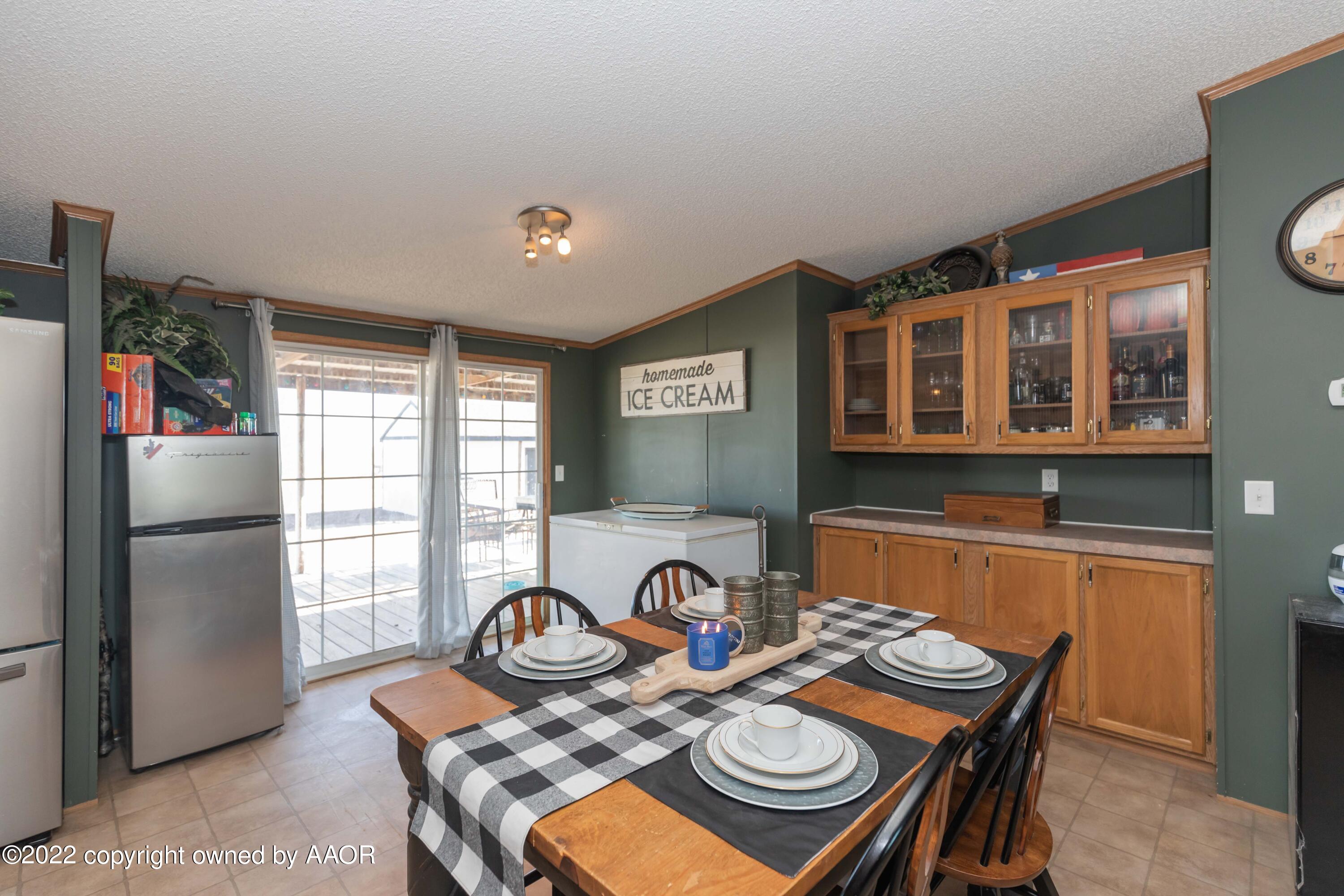 5600 Tomahawk Trail Amarillo, TX 79124 - Photo 11 of 36 a view of a dining room with furniture a kitchen and chandelier