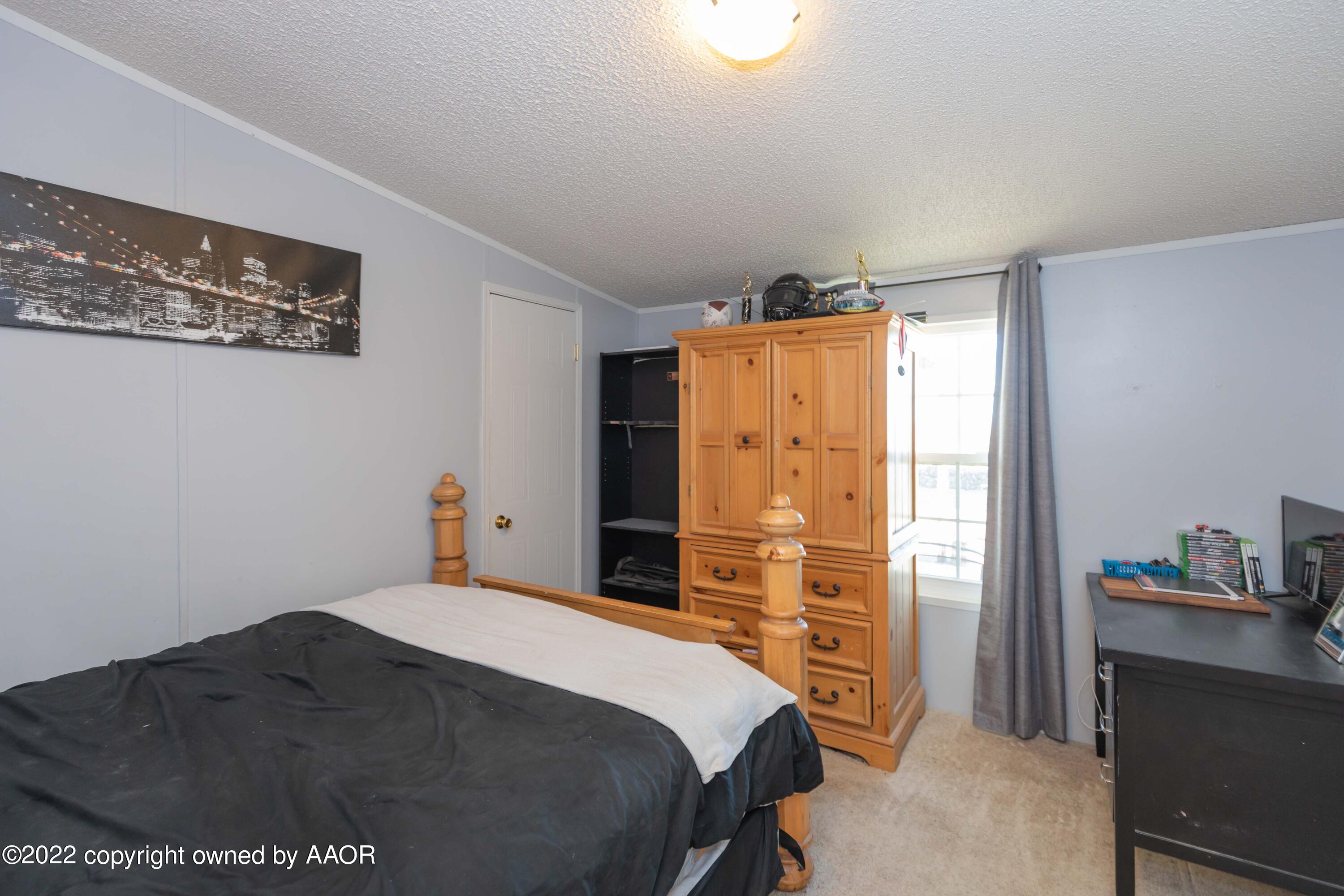 5600 Tomahawk Trail Amarillo, TX 79124 - Photo 27 of 36 a bedroom with a bed and a dresser