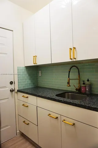 a kitchen with sink and cabinets