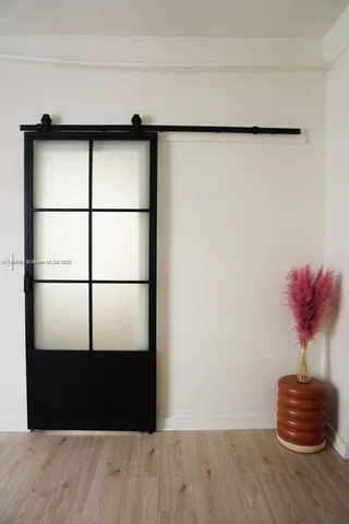 a picture of a glass door with wooden floor