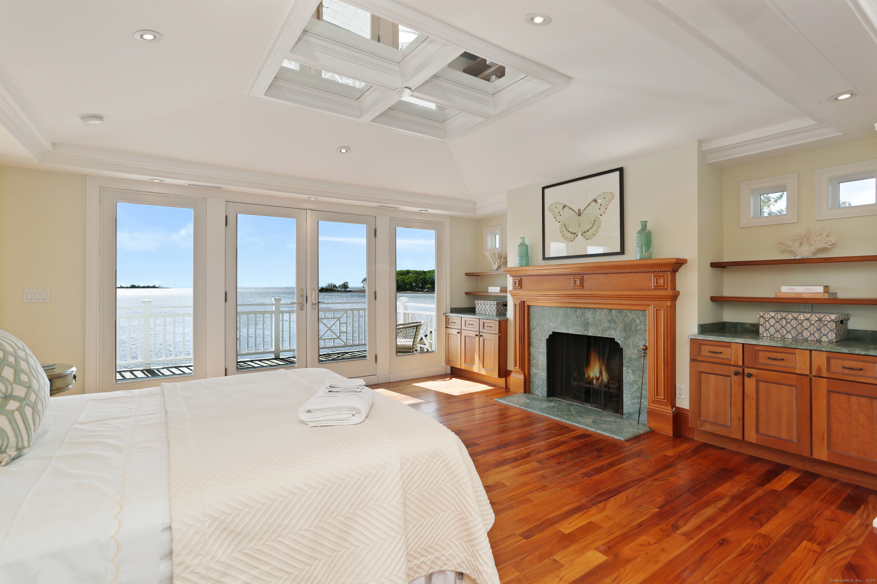 34 Shorehaven Road Norwalk, CT 06855 - Photo 21 of 40 a spacious bedroom with a large bed and a fireplace