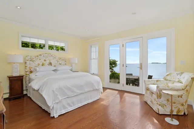 a bedroom with a bed and large window