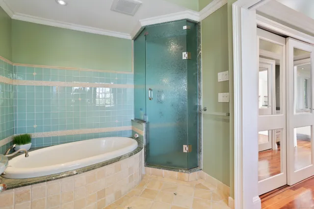 a bathroom with a tub and shower