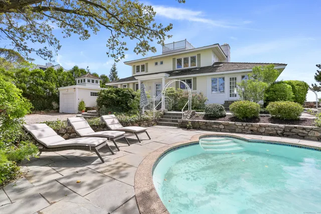 a view of a house with backyard porch and sitting area