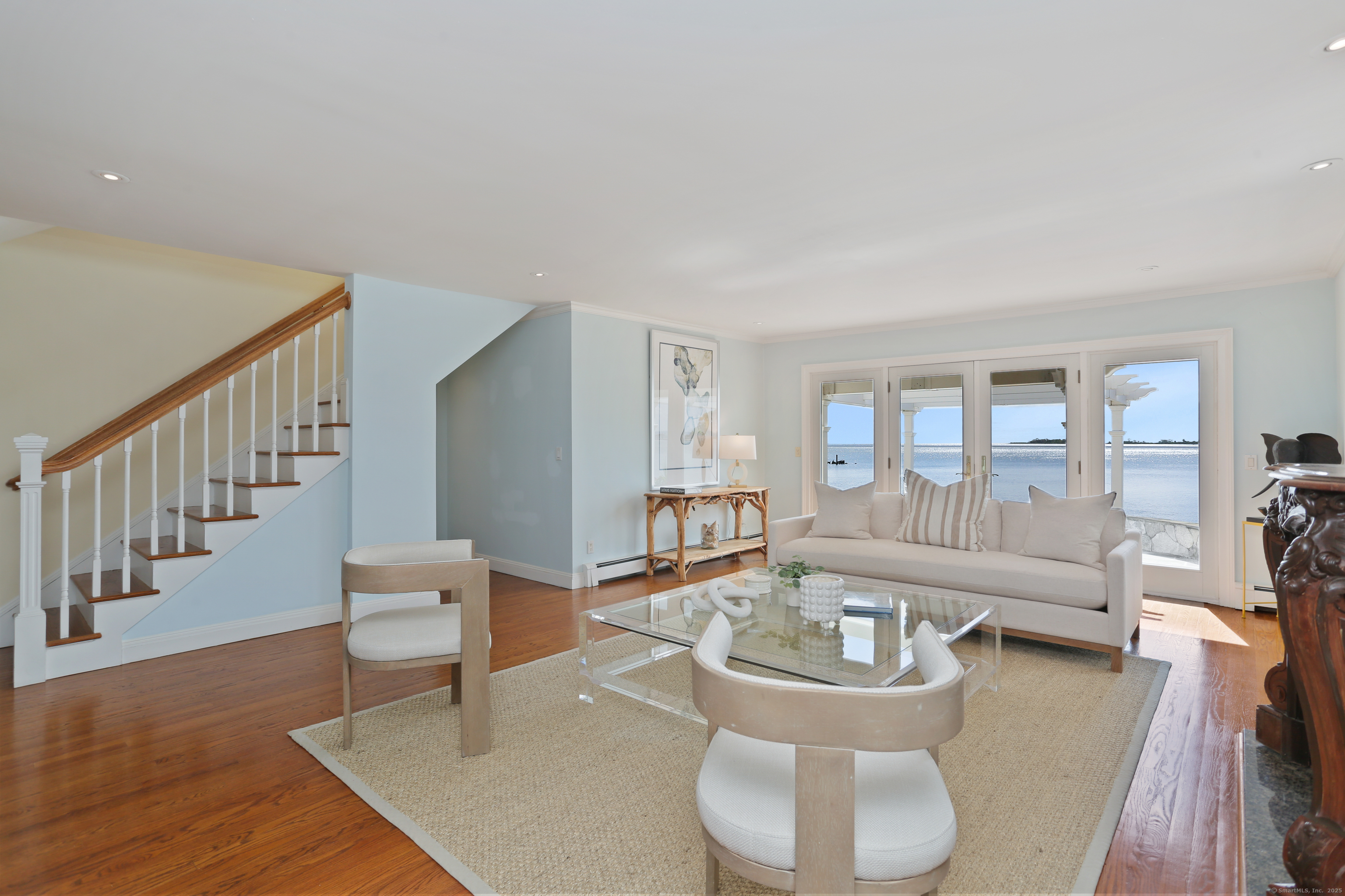34 Shorehaven Road Norwalk, CT 06855 - Photo 6 of 40 a living room with couches and a dining table with wooden floor