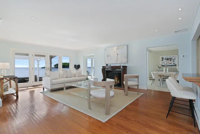 a living room with fireplace furniture and a wooden floor