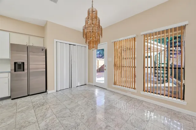 a kitchen with white cabinets and white stainless steel appliances