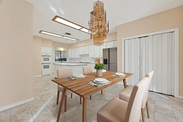 a large kitchen with white cabinets and appliances