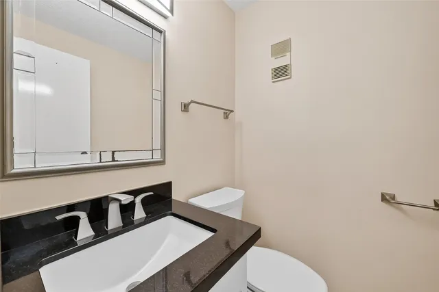 a spacious bedroom with a bed and wooden floor