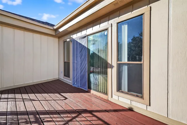 a view of a balcony with wooden floor