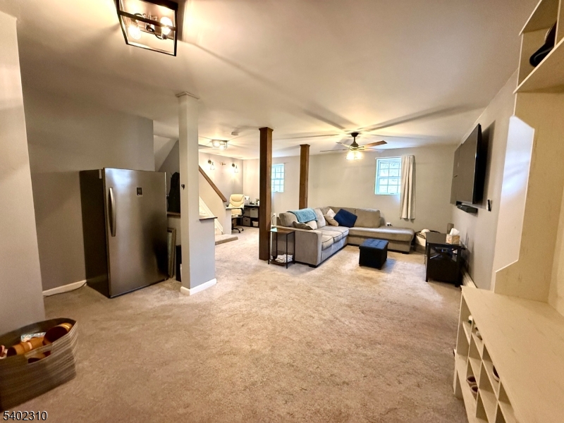 117 Papscoe Road West Milford, NJ 07421 - Photo 13 of 29 a living room with furniture a flat screen tv and a large window