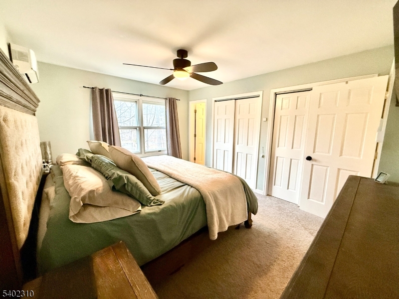 117 Papscoe Road West Milford, NJ 07421 - Photo 15 of 29 a spacious bedroom with a bed and a chandelier