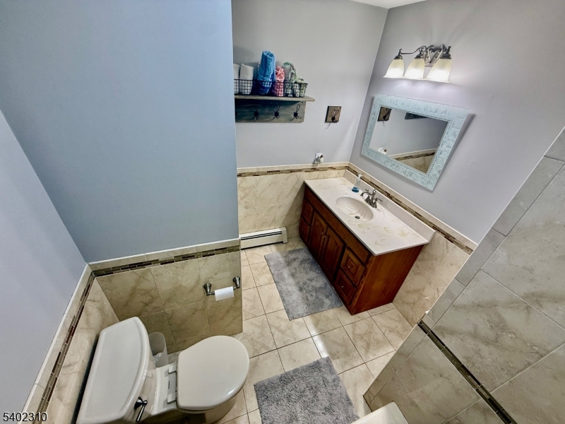 117 Papscoe Road West Milford, NJ 07421 - Photo 19 of 29 a living room with furniture and a mirror