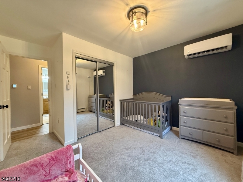 117 Papscoe Road West Milford, NJ 07421 - Photo 20 of 29 a bedroom with a bed and a chandelier