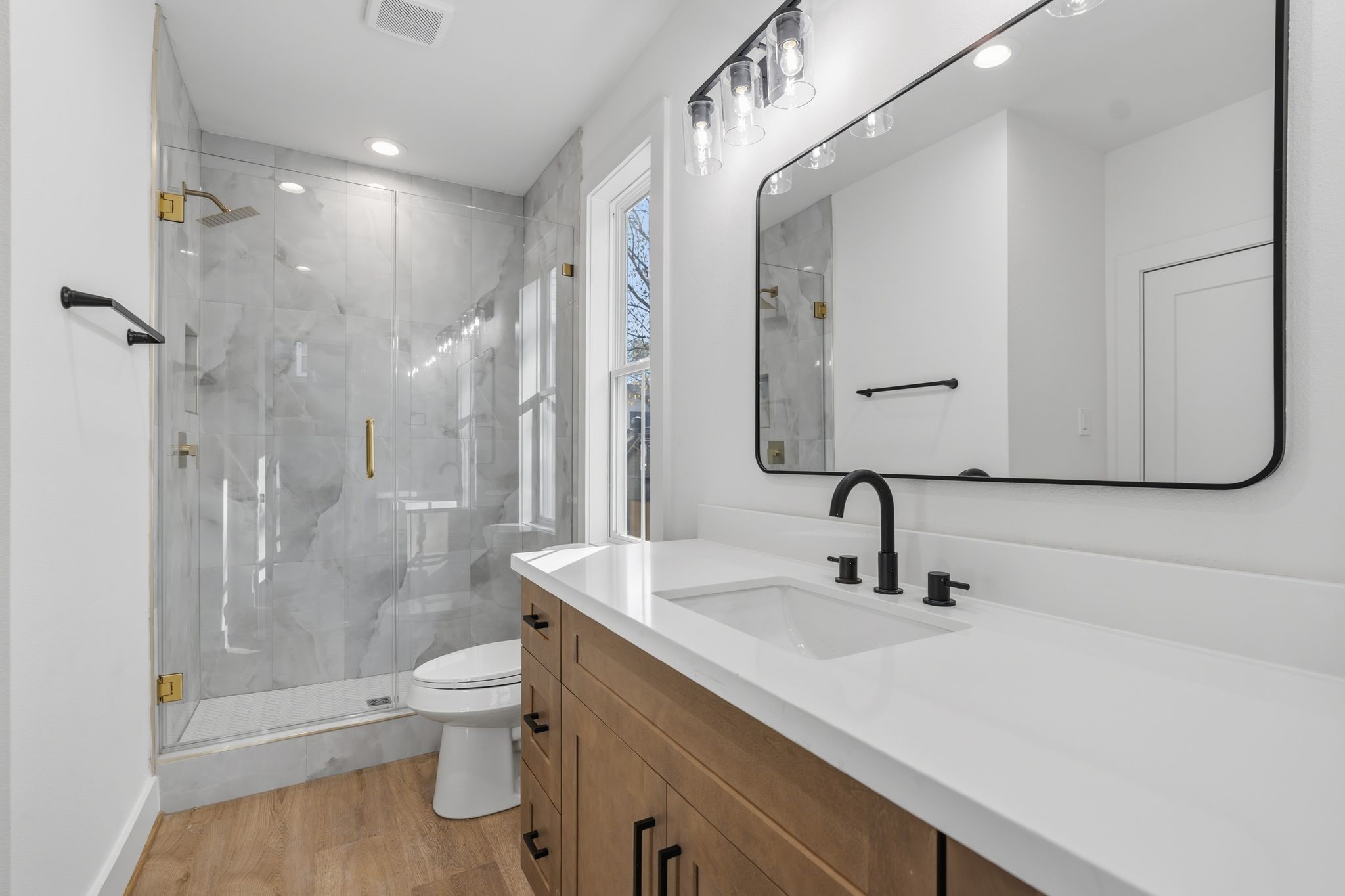 1140 West 16th Street Houston, TX 77008 - Photo 17 of 23 a bathroom with a sink a toilet and shower