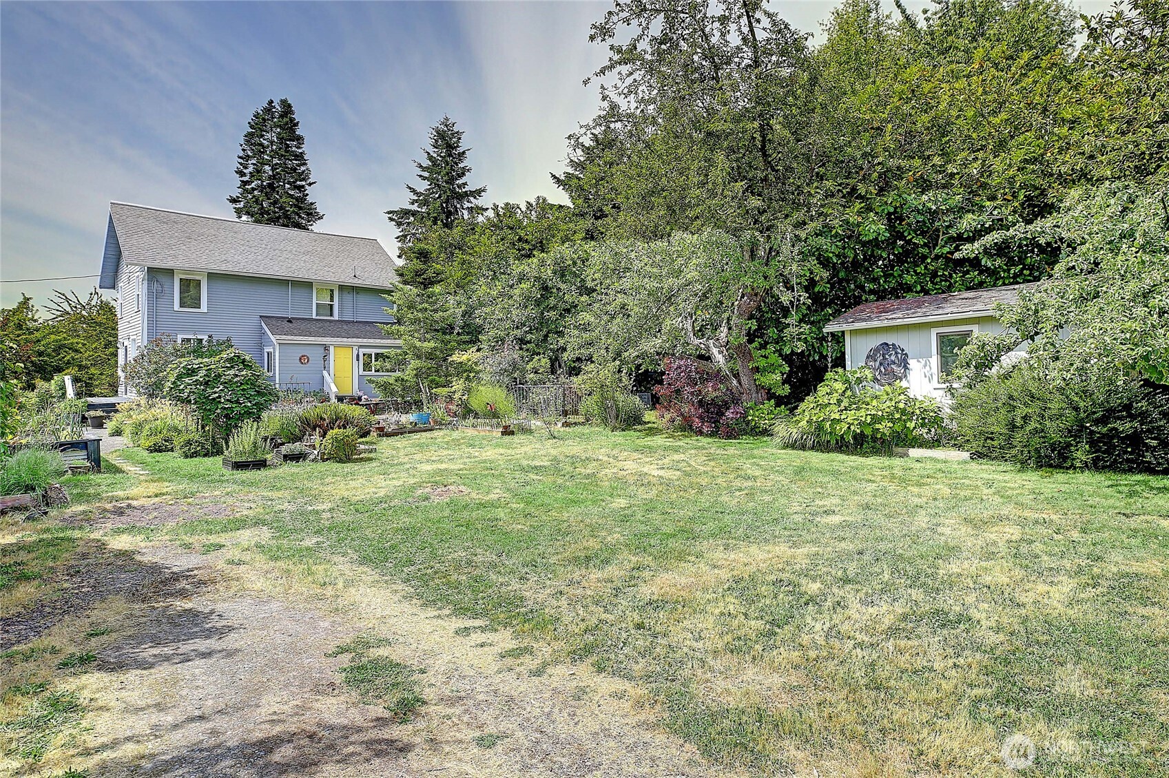 a view of a house with yard and a tree