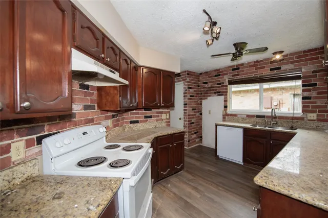 a kitchen with a sink stove and cabinets