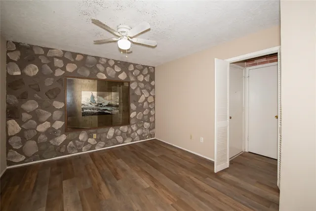 wooden floor in an empty room with a fireplace