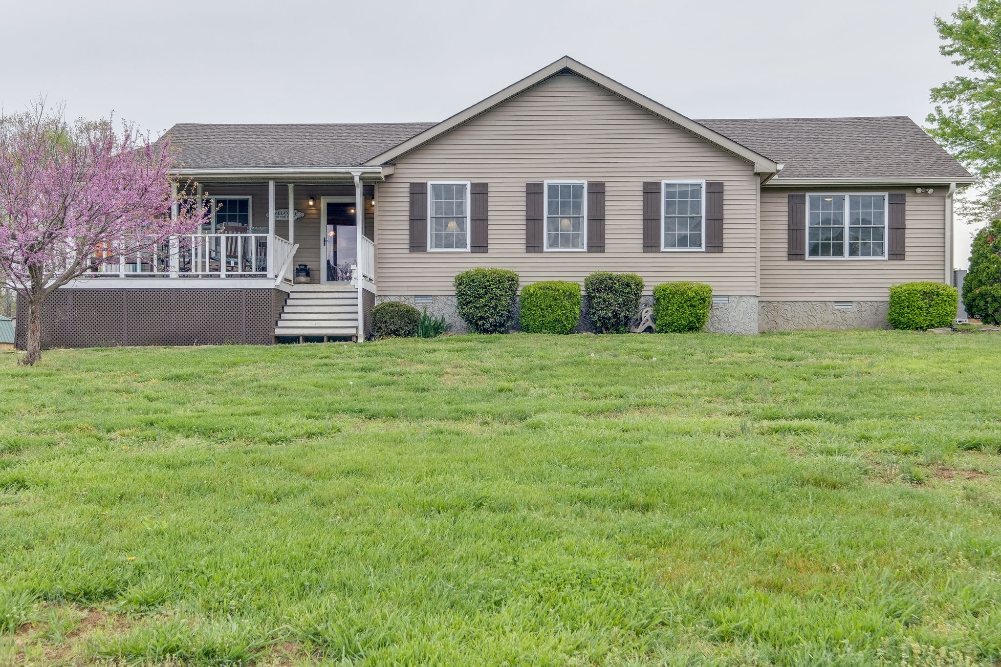 a front view of house with yard and green space
