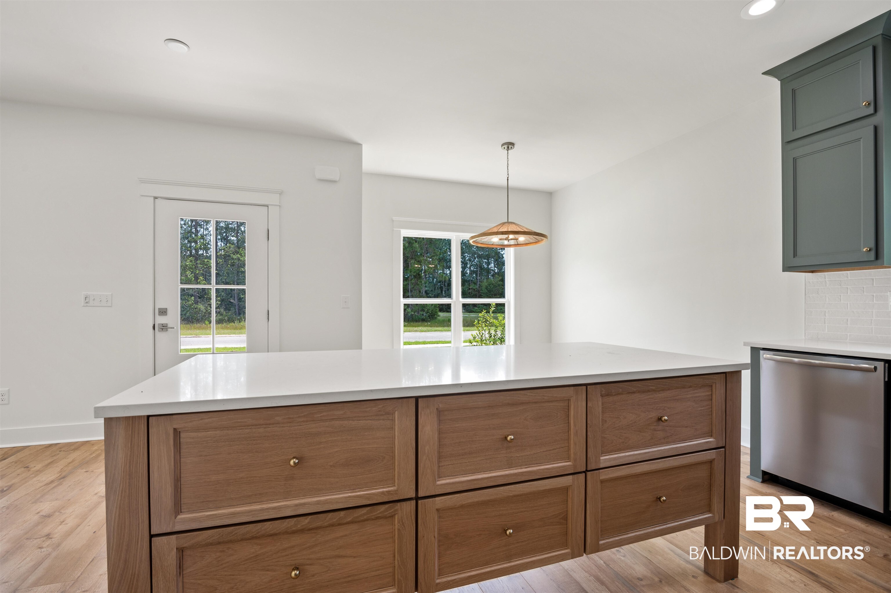 657 Island Way Gulf Shores, AL 36542 - Photo 4 of 59 Kitchen with dishwasher, light wood finished floors, light countertops, recessed lighting, and pendant lighting