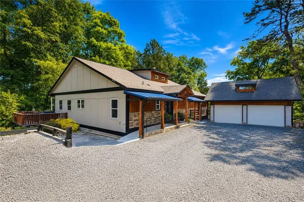a view of a house with backyard and a sitting area