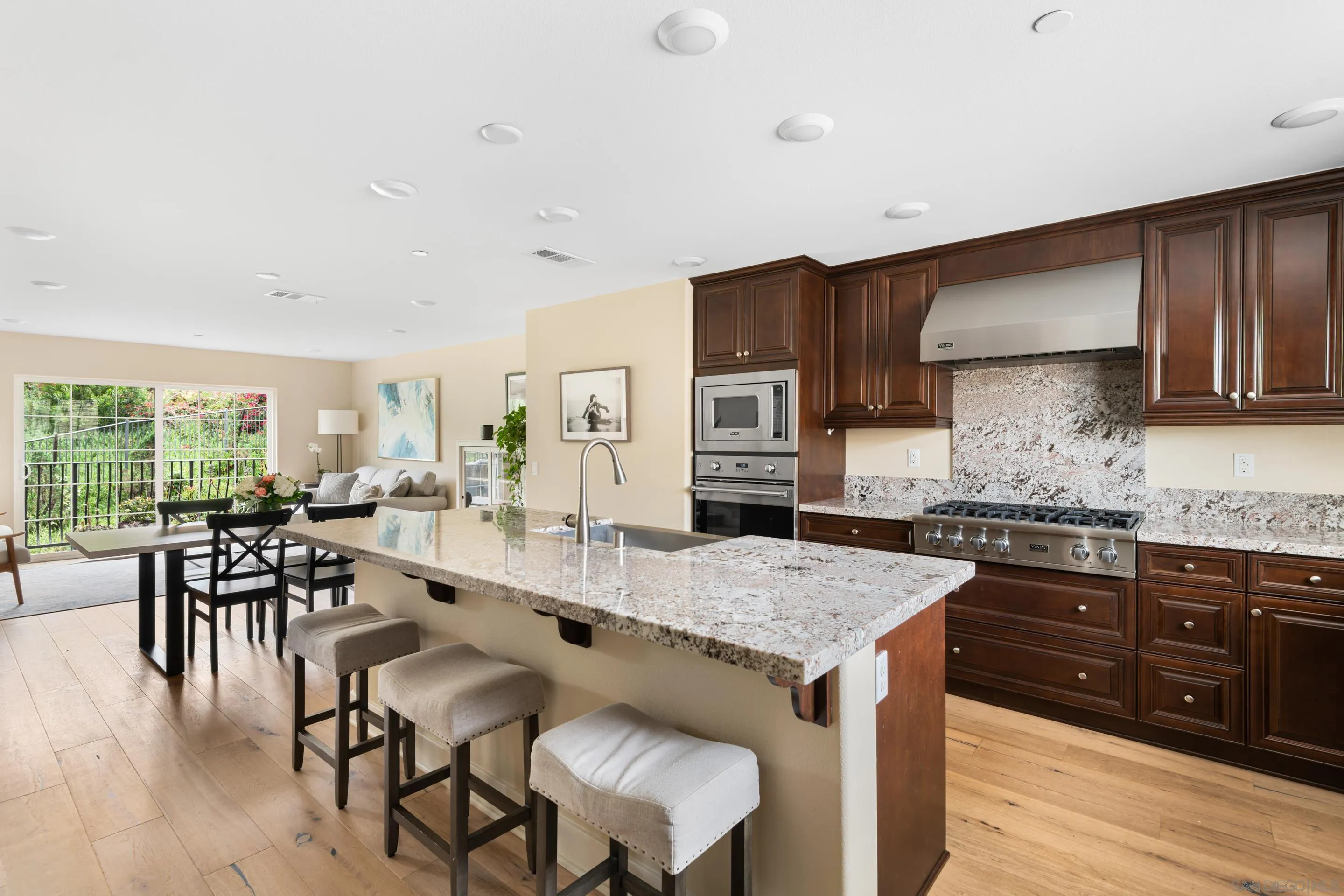 a view of kitchen with granite countertop cabinets table and chairs