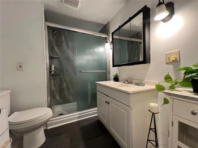 a bathroom with a sink toilet and shower