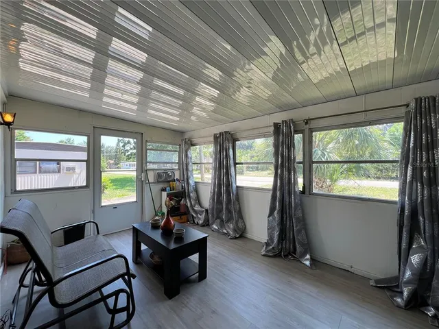 a living room with furniture and large windows