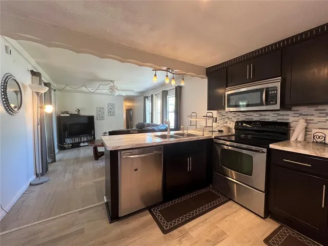 a kitchen with stainless steel appliances granite countertop a stove and a sink