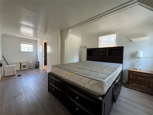 a bedroom with a bed and a dresser