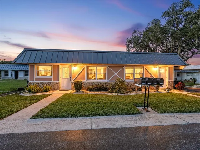 a view of a house with a yard