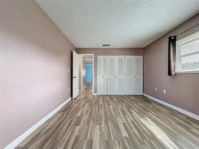a view of a room with wooden floor