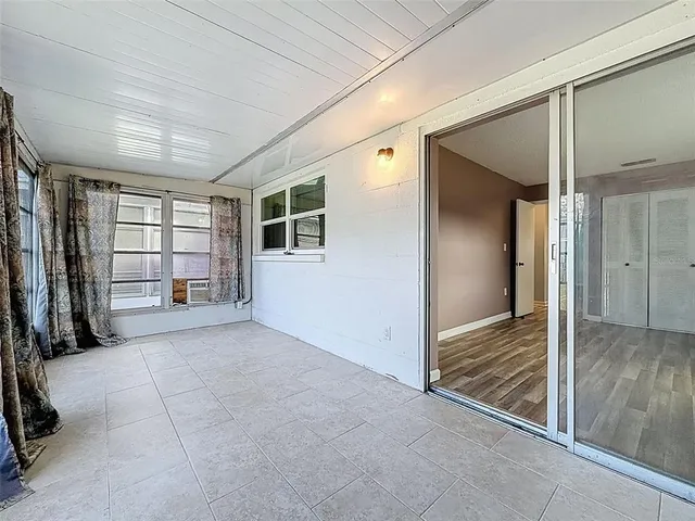 an empty room with windows and closet