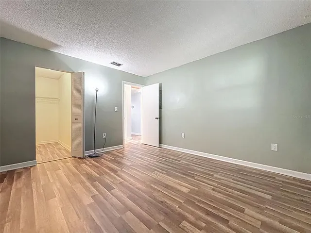 a view of an empty room and wooden floor